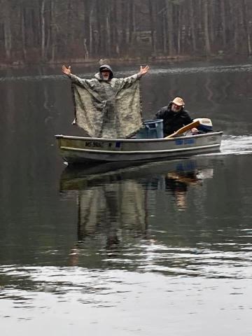Guys on boat posing for photo