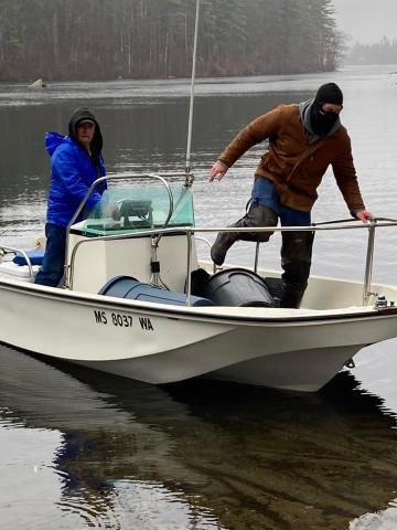 Men on boat stocking fish