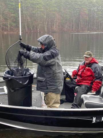 Men on boat stocking fish